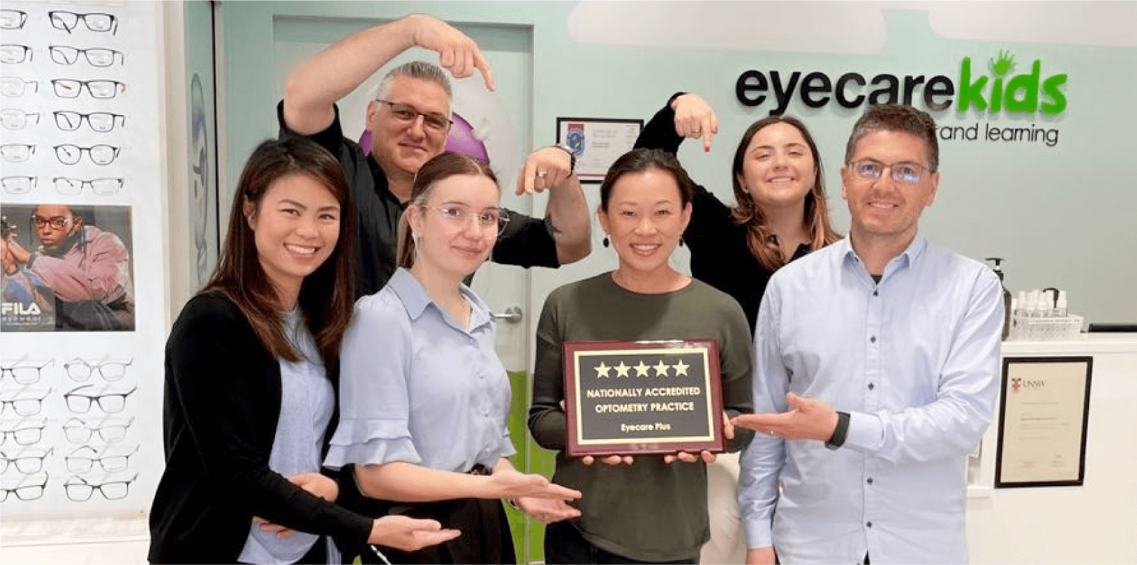 Eyecare Kids Optometrist and owner, Dr SooJin Nam, proudly holds the plaque together with her trusted team: Operations Manager Trevor, Optometrists Dr Claresta and Dr Frances, Practice Manager Tori and Optical Dispenser Chris 